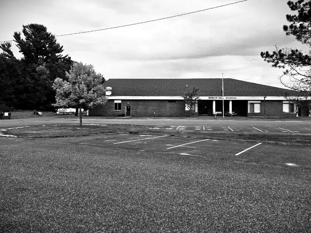Front view of the middle school I attended before it shut down temporarily for the COVID pandemic. An empty parking lot became expected of it daily.